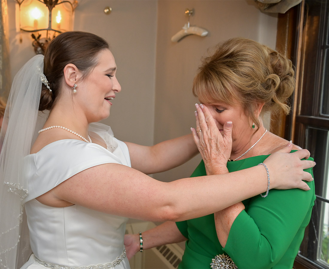 The bride comforts her mother after she sees her in her wedding dress at the Bull Estate at Addison Oaks in Leonard, Michigan.