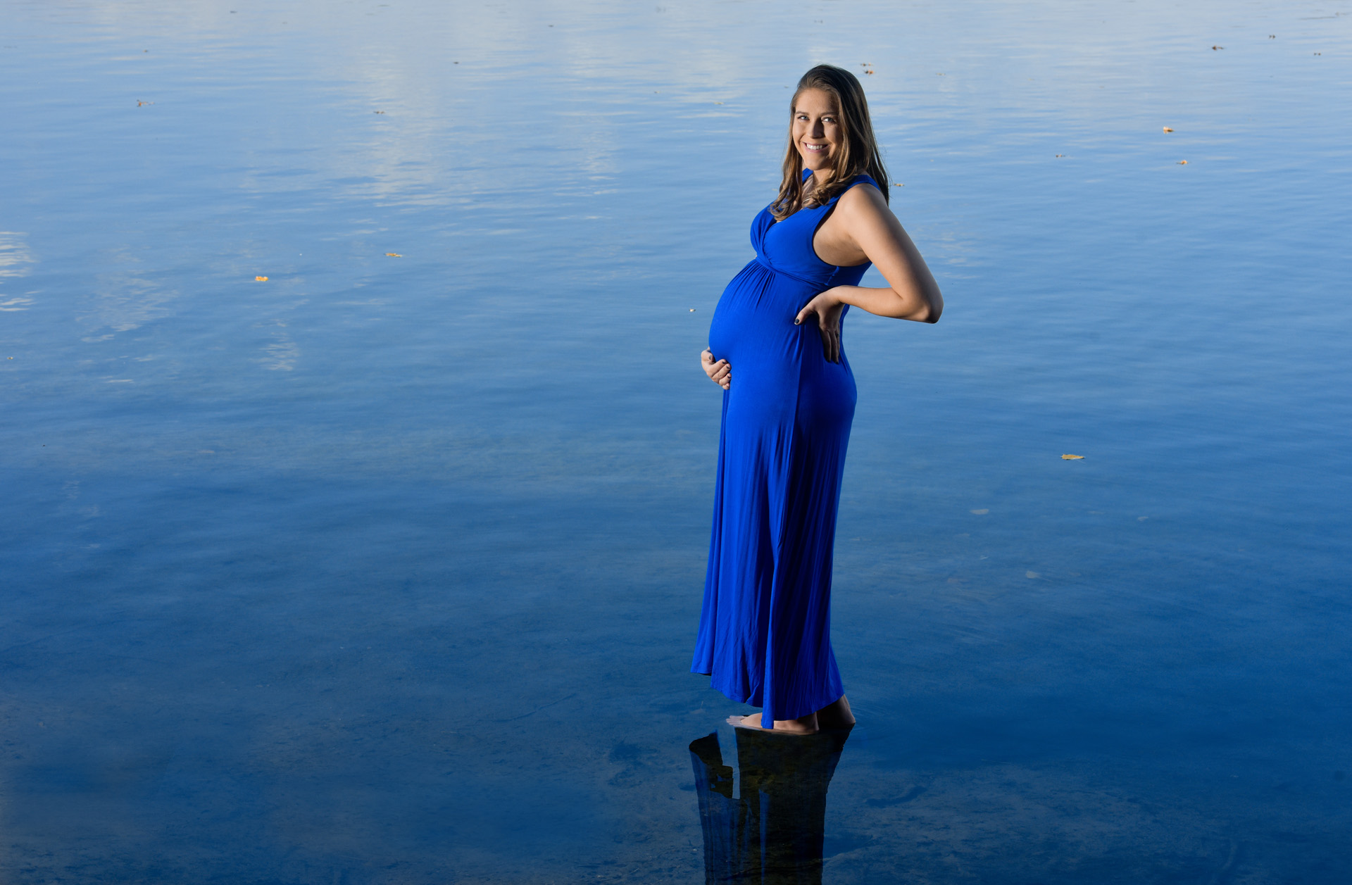 Super creative maternity photography taken with an 8 month pregnant woman floating on a lake in Rochester, Michigan.