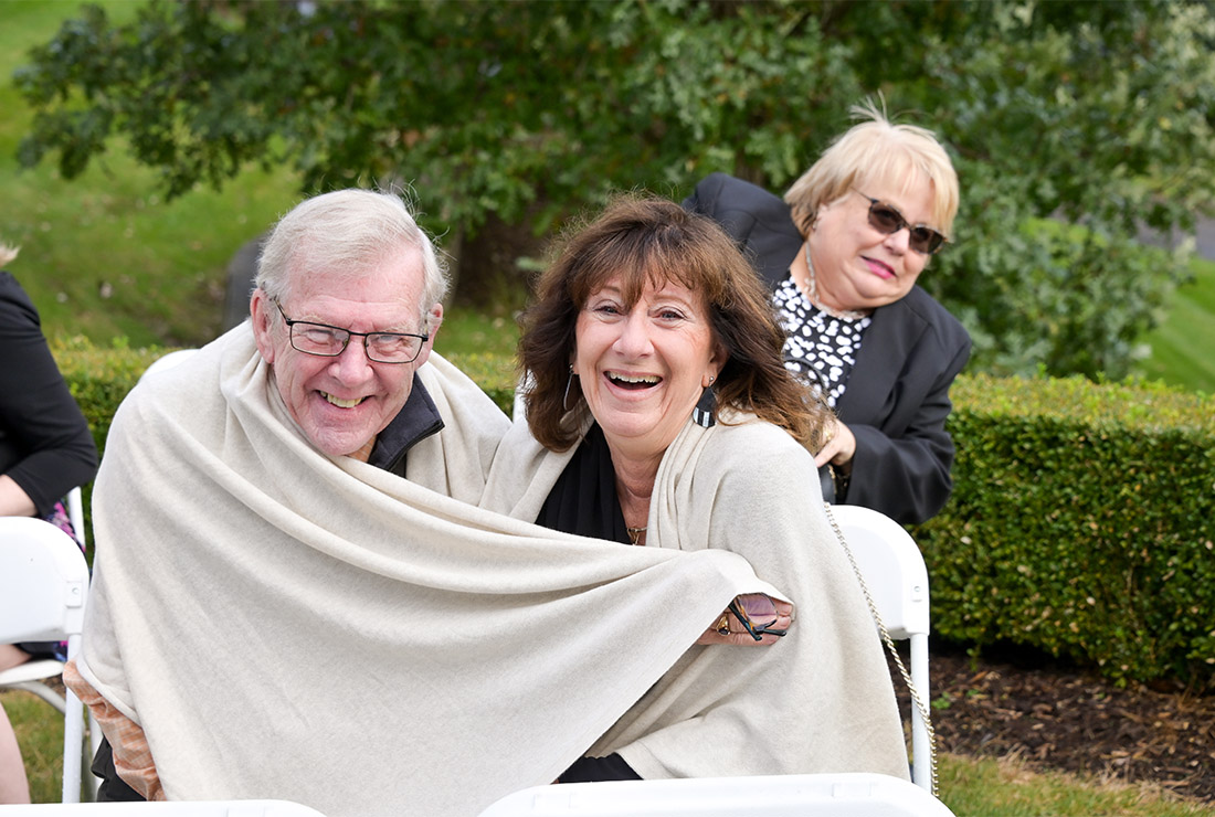 Guests bundle up before the windy outdoor wedding ceremony at Beacon Hill Golf Club in Commerce Township,  Michigan.