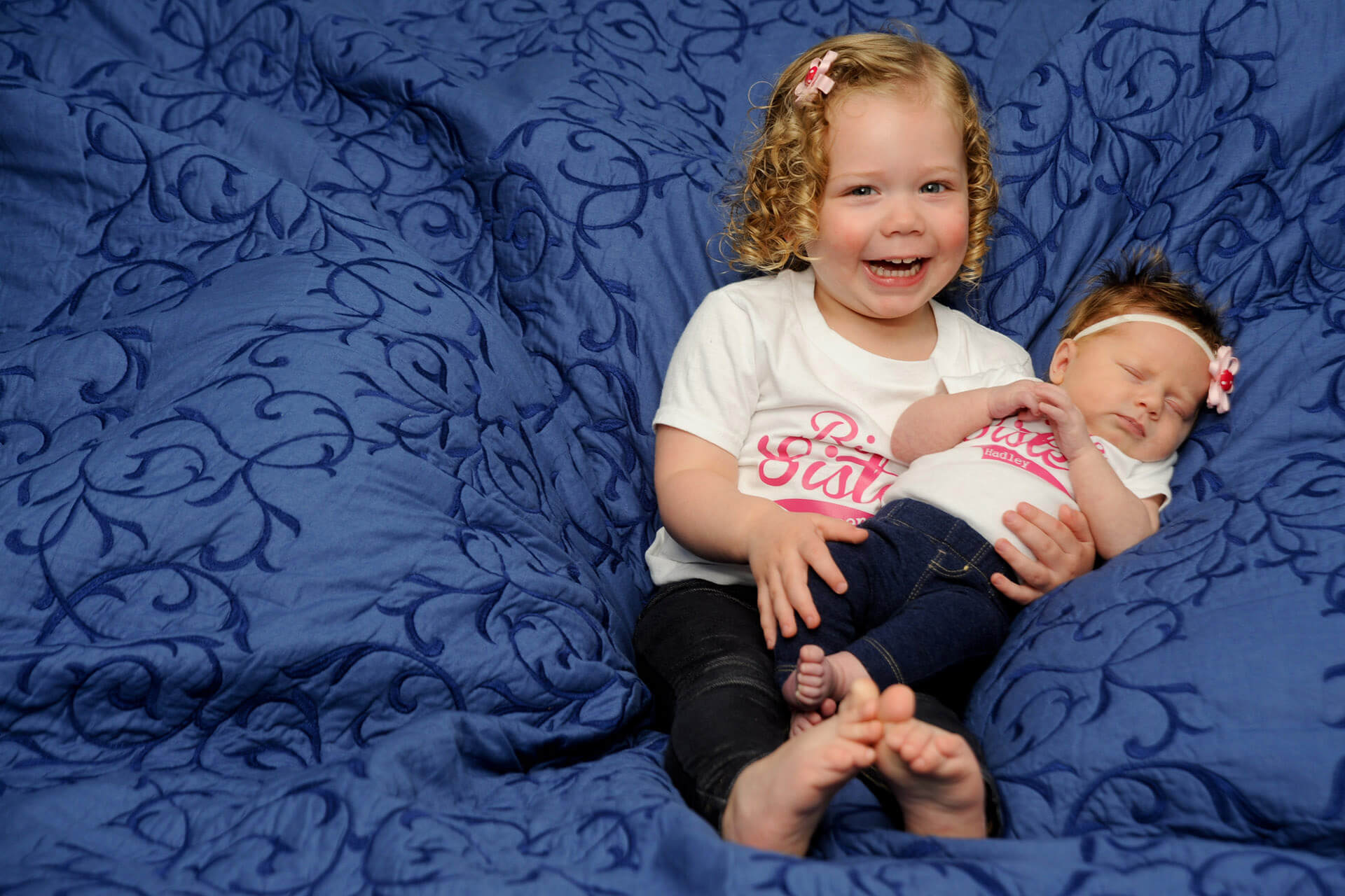 Best Detroit baby photographer works with families to capture first photos with siblings in their metro Detroit, Michigan area homes for baby picture photo shoots.