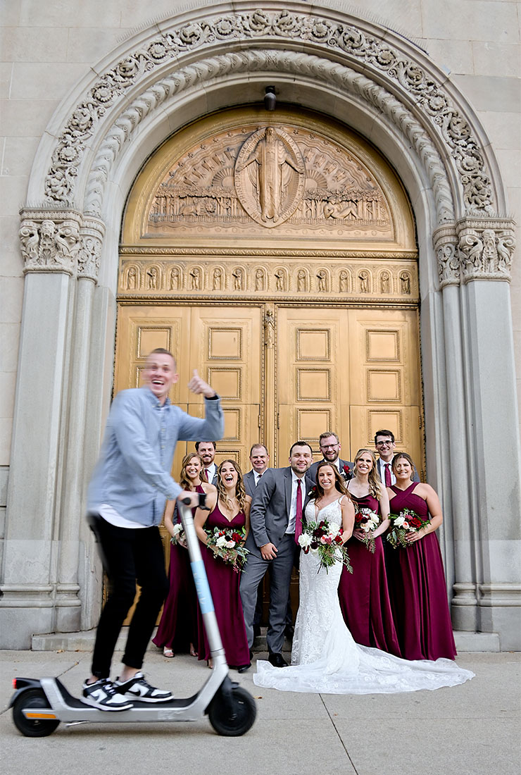 The wedding party gets photo bombed by a friend of their while taking photos in Detroit, Michigan.