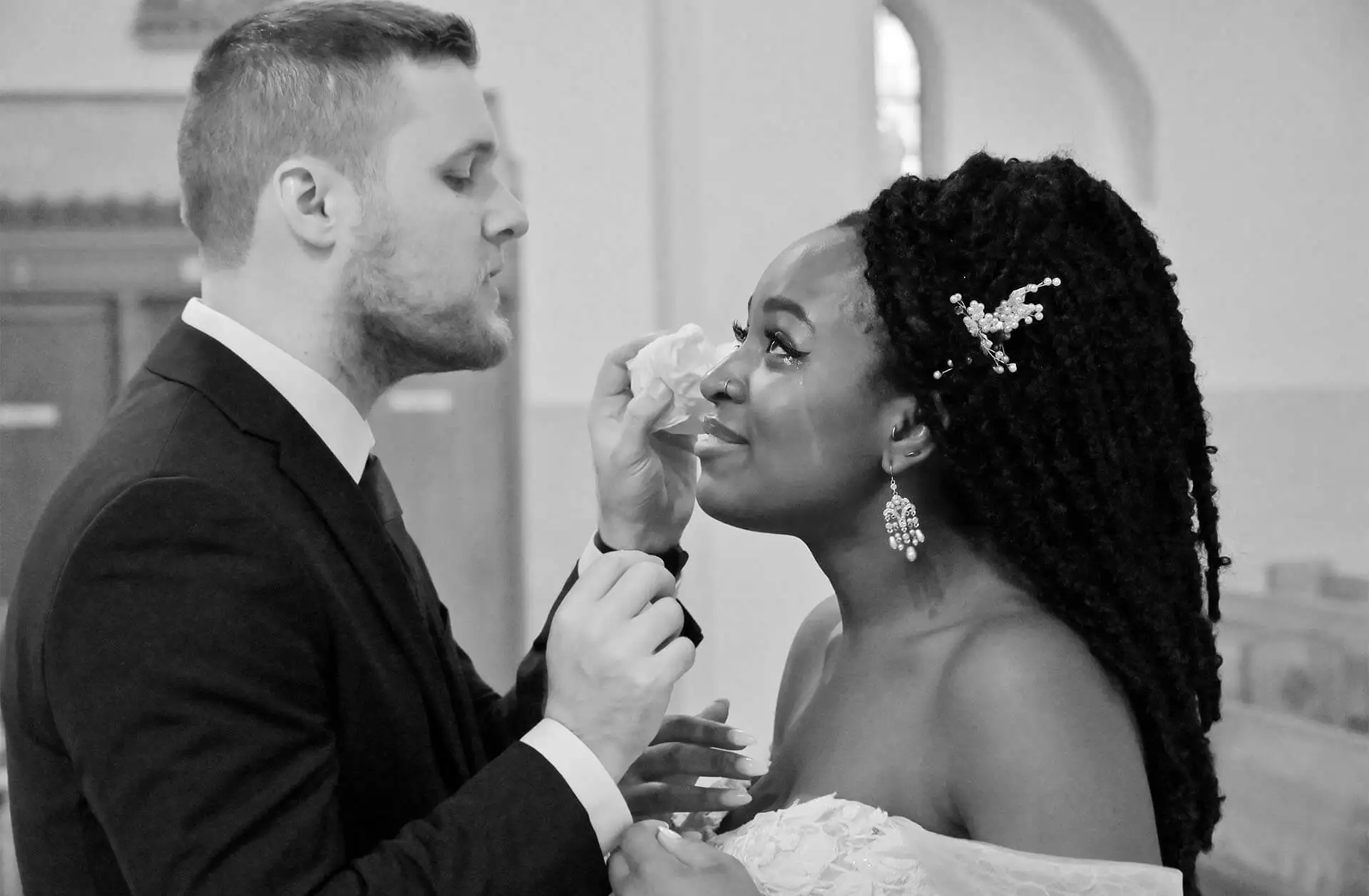The groom dries the bride's eyes after an emotional First Look at her church in Troy, Michigan.