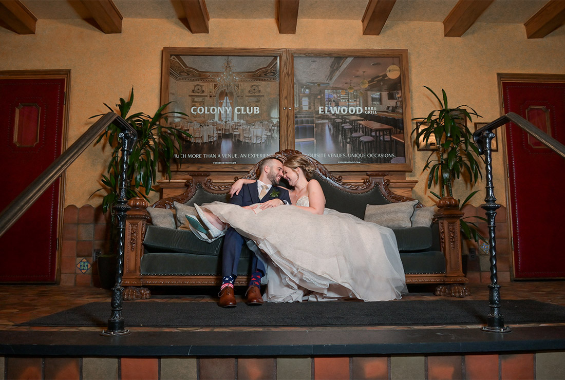 The bride and groom take a breather during their wedding at the Gem Theater wedding in Detroit, Michigan.