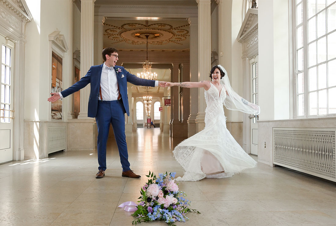 The bride and groom practice a twirl at the Henry Ford Museum in Dearborn, Michigan before their wedding.