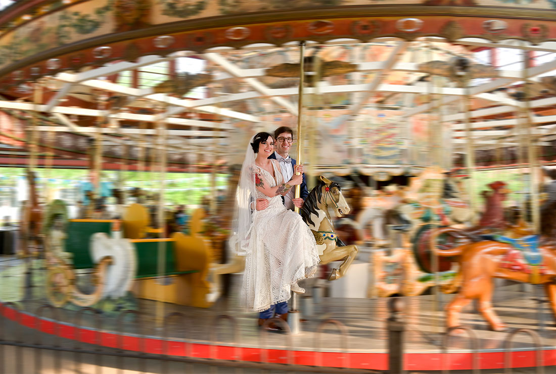 The bride and groom on the antique carousel at the Henry Ford Museum in Dearborn, Michigan.