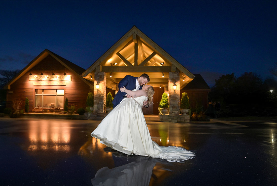 The bride and groom do their dip on the freezing pavement outside the Iroquois Club in Bloomfield Hills, Michigan.