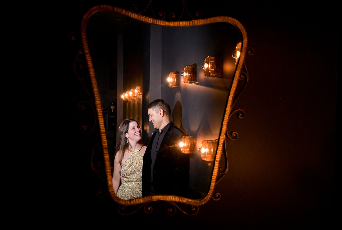 The bride and groom reflected in a mirror after their wedding at the Siren Hotel in Detroit, Michigan.