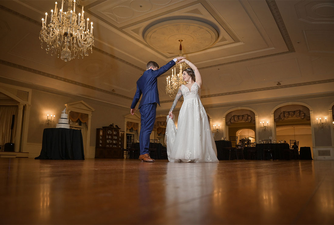 The bride and groom practice their first dance after their wedding at Lovett Hall at the Henry Ford Museum in Detroit, Michigan before the guests arrive.