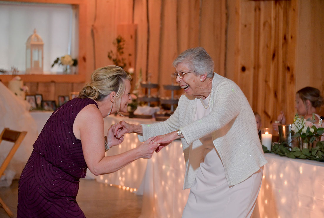 The mother of the groom dances with the bride's grandmother during a wedding in Lainsburgh Michigan.