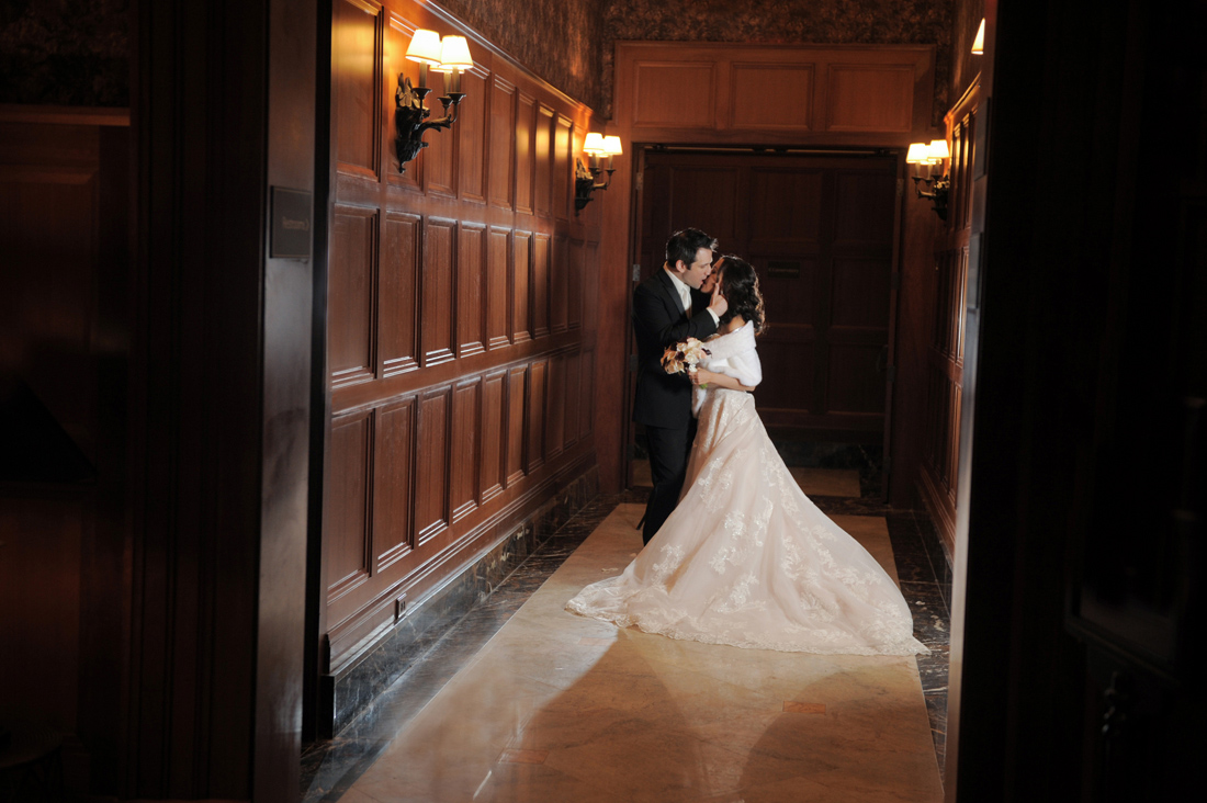 An artistic couple at the Royal Park Hotel in Rochester share a spectacularly hollywood style kiss after their intimate ceremony in Rochester, Michigan.