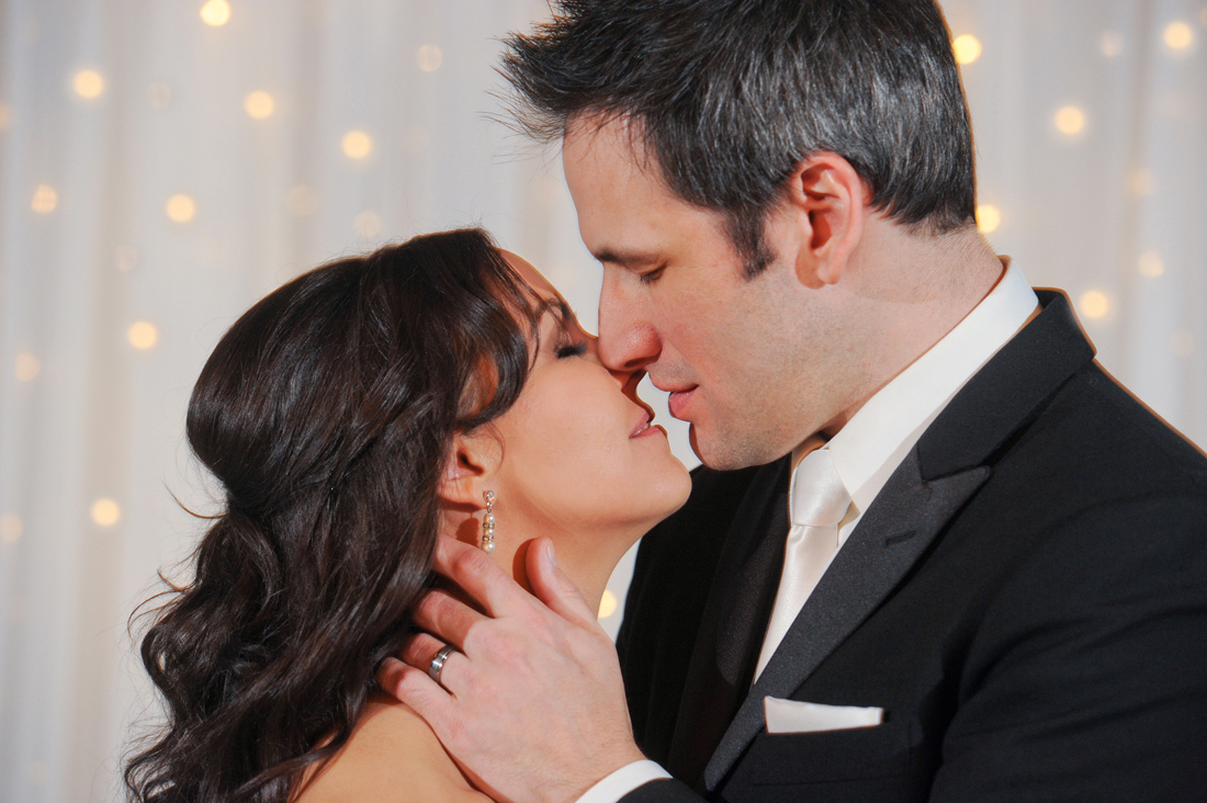 An artistic couple at the Royal Park Hotel in Rochester kiss during their intimate ceremony in Rochester, Michigan.