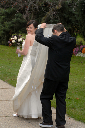 A Ferndale, Michigan wedding groom takes a peak under his bride's dress.