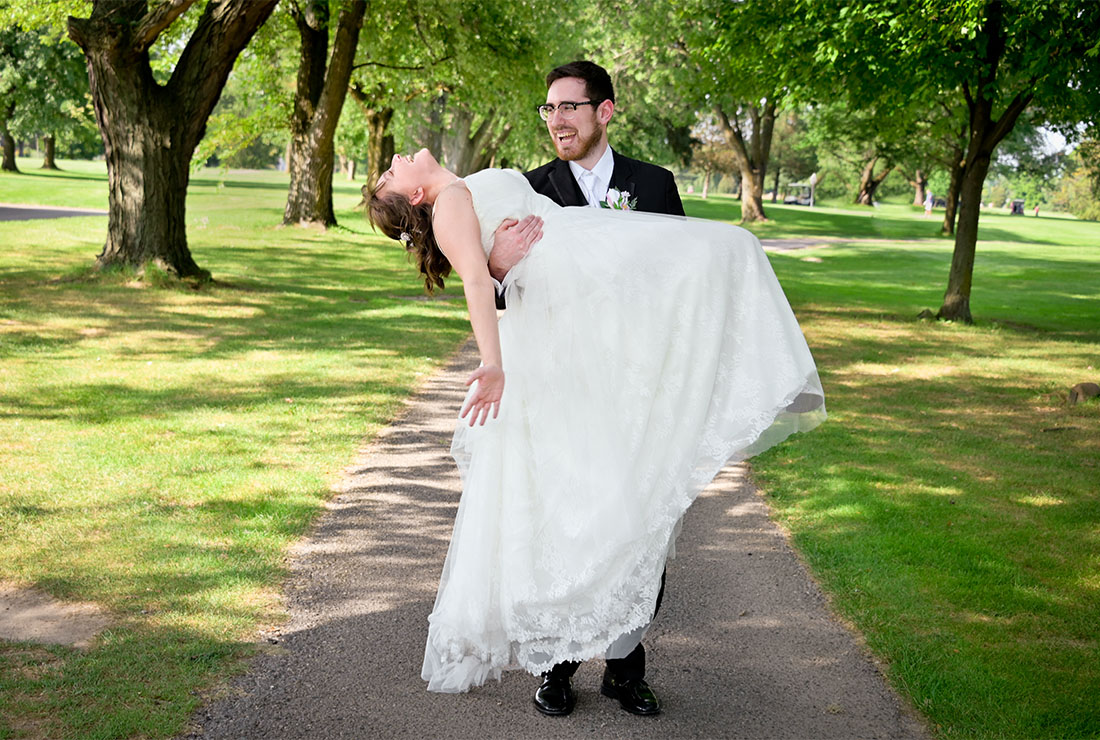 The groom carrying his wife after their wedding in Livonia, Michigan.