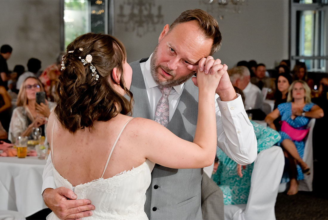 The bride's father cries during their dance in Livonia,  Michigan.