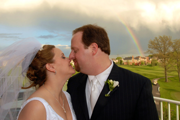 Beacon Hills Michigan couple kiss under rainbow