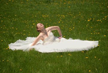 The bride plays in a field of dandelions at her Michigan farm.
