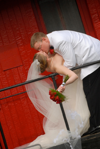 The groom dips the bride off a train in Macomb county in Michigan