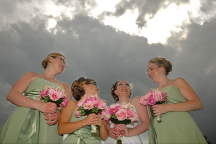 The bride and bridesmaids wait out a storm before her outdoor ceremony in White Lake Michigan