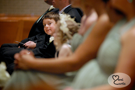 the ring bearer gets playful during the wedding ceremony