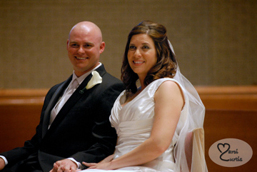 The bride and groom listen to the priest during their Macomb Michigan wedding