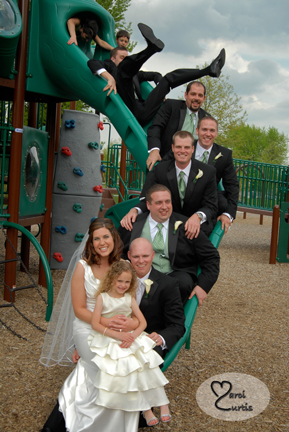 Part of the wedding party plays on the slides on the way to their MI wedding reception