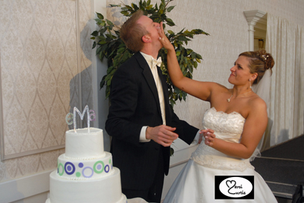 The bride slams wedding cake into the groom's face during their Ann Arbor wedding reception.