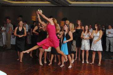 Wedding guest dives for bouquet during a Macomb County wedding reception