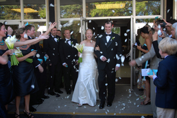 The bride and groom are pelted with rose pedals on their exit out of their Grosse Pointe Michigan church.