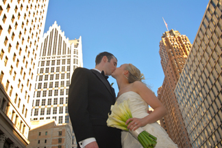 The bride and groom kiss downtown Detroit, MI