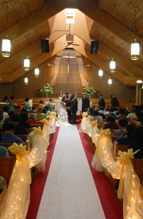 =bride and groom during their ceremony at the AME church in Southfield, MI