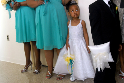 The flowergirl looks at the other attendants after their ceremony in Southfield, MI