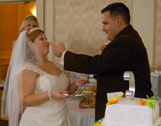 Warren Michigan couple put frosting on their noses during cake cutting.