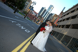 The bride and groom kiss outside the Gem Theatre in downtown detroit Michigan