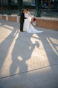 The bride and groom share a kiss at Comerica park downtown Detroit, MI