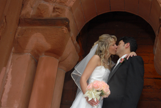 The bride and groom smooch at their downtown Detroit church