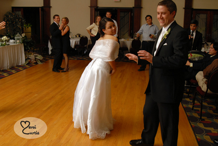 The bride teases the groom about dancing during their midland, Michigan wedding reception