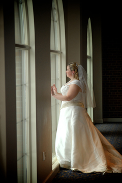 St. Johns bride against some of their windows before her wedding