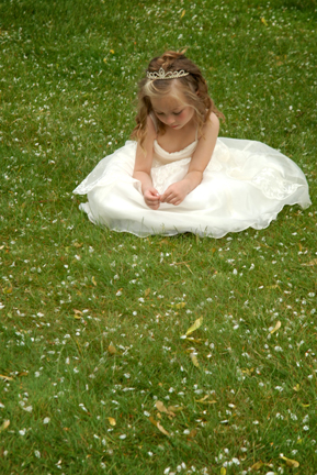 Flower girl picks at weeds after a Port Huron Michigan wedding