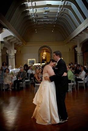 bride and groom dance in the Henry Ford Museum at their reception in Dearborn, Michigan