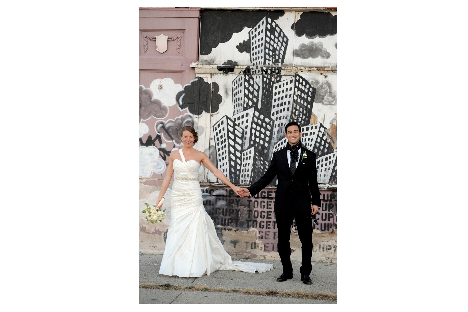 The Historic church Sweetest Heart of Mary and the Dearborn Inn of Detroit's historic church in Detroit and Dearborn, Michigan wedding photographer's photo of the couple near the Detroit's historic train station for wedding photos in Detroit, Michigan with local graffiti art.