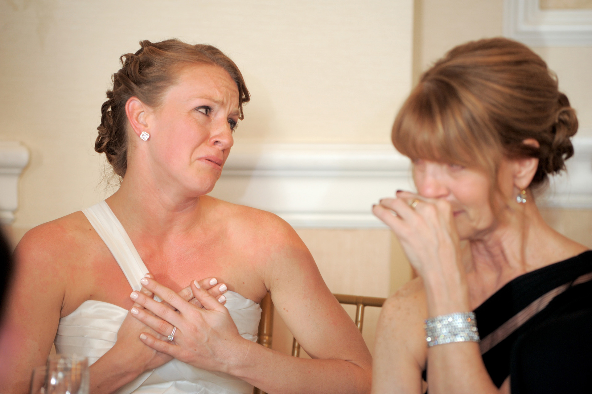 The Historic church Sweetest Heart of Mary and the Dearborn Inn of Detroit's historic church in Detroit and Dearborn, Michigan wedding photographer's photo of the bride and her mother starting to cry during the toasts at the wedding at the wedding reception at the Dearborn Inn in Dearborn, Michigan..