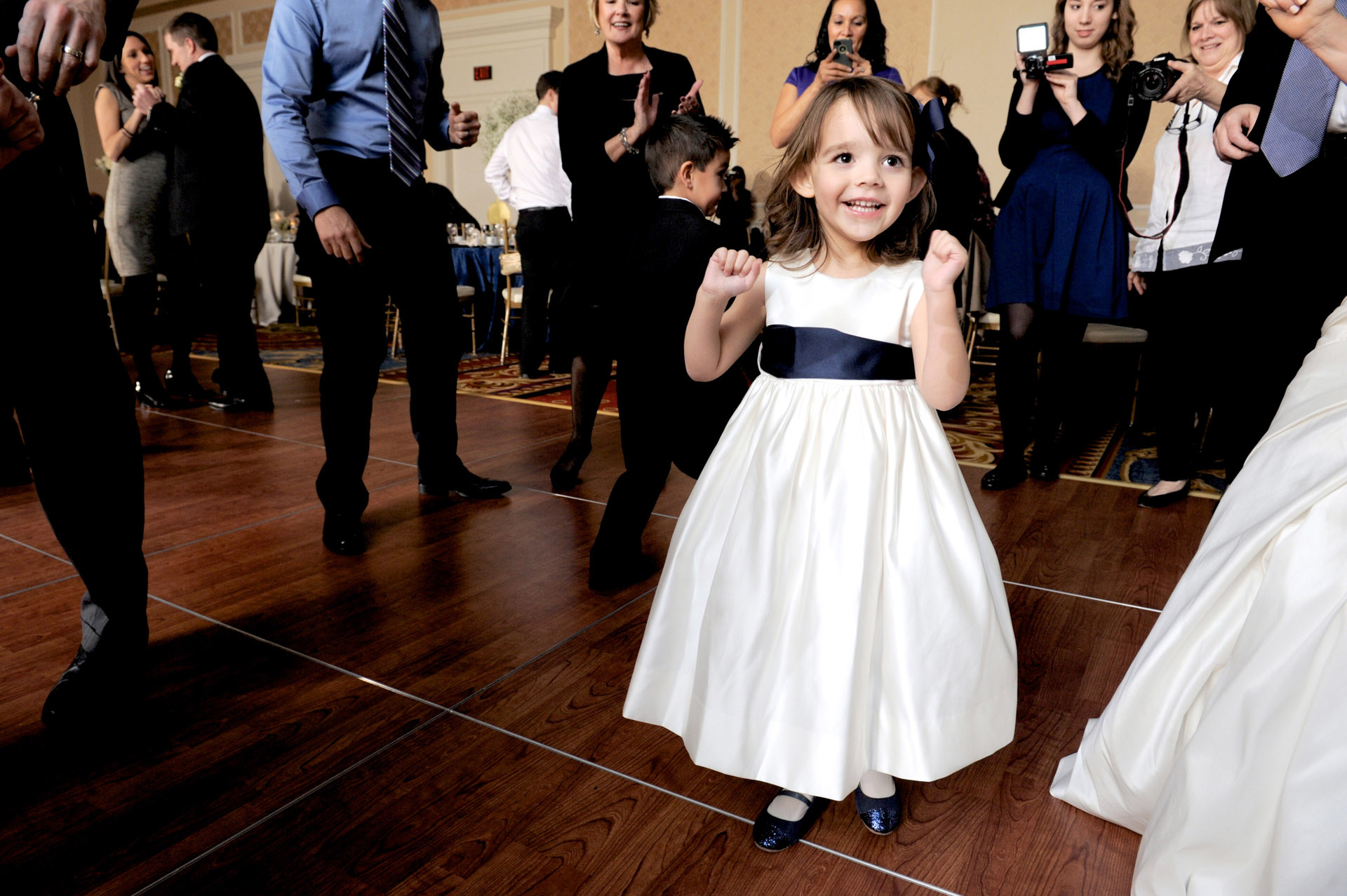 The Historic church Sweetest Heart of Mary and the Dearborn Inn of Detroit's historic church in Detroit and Dearborn, Michigan wedding photographer's photo of a couple of the flower girl dancing at the wedding reception at the Dearborn Inn in Dearborn, Michigan.