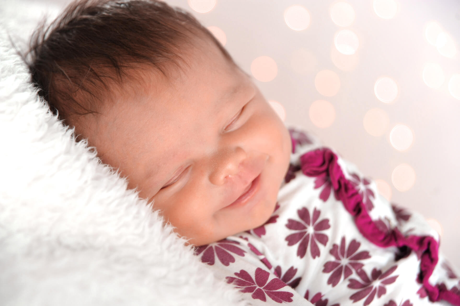 Best Detroit baby photographer is happy to photograph infants smiling in their sleep during their photography sessions in metro Detroit, Michigan.