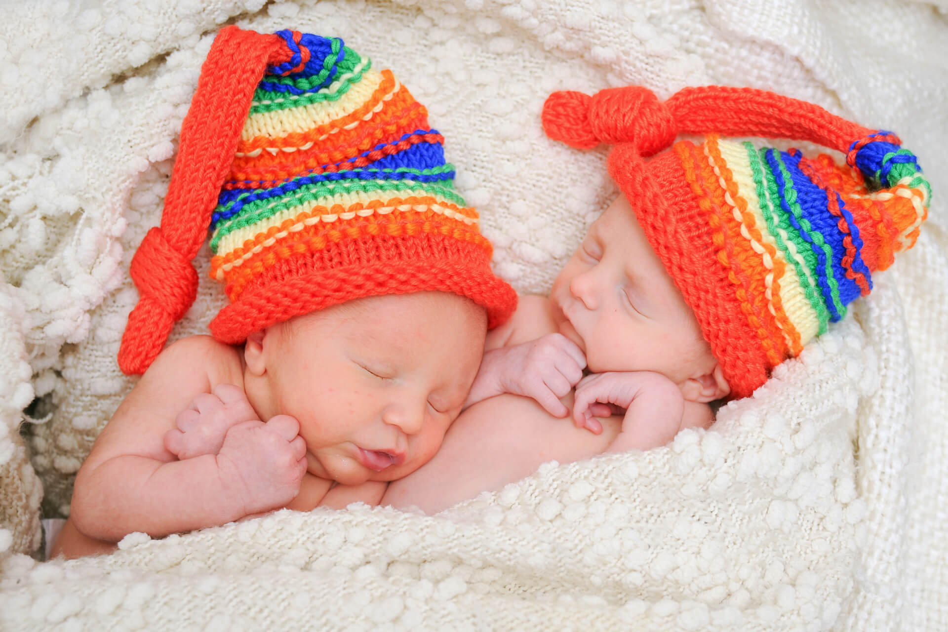 Best Detroit baby photographer photographs rainbow twins during their 6 day old newborn lifestyle session in metro Detroit, Michigan.