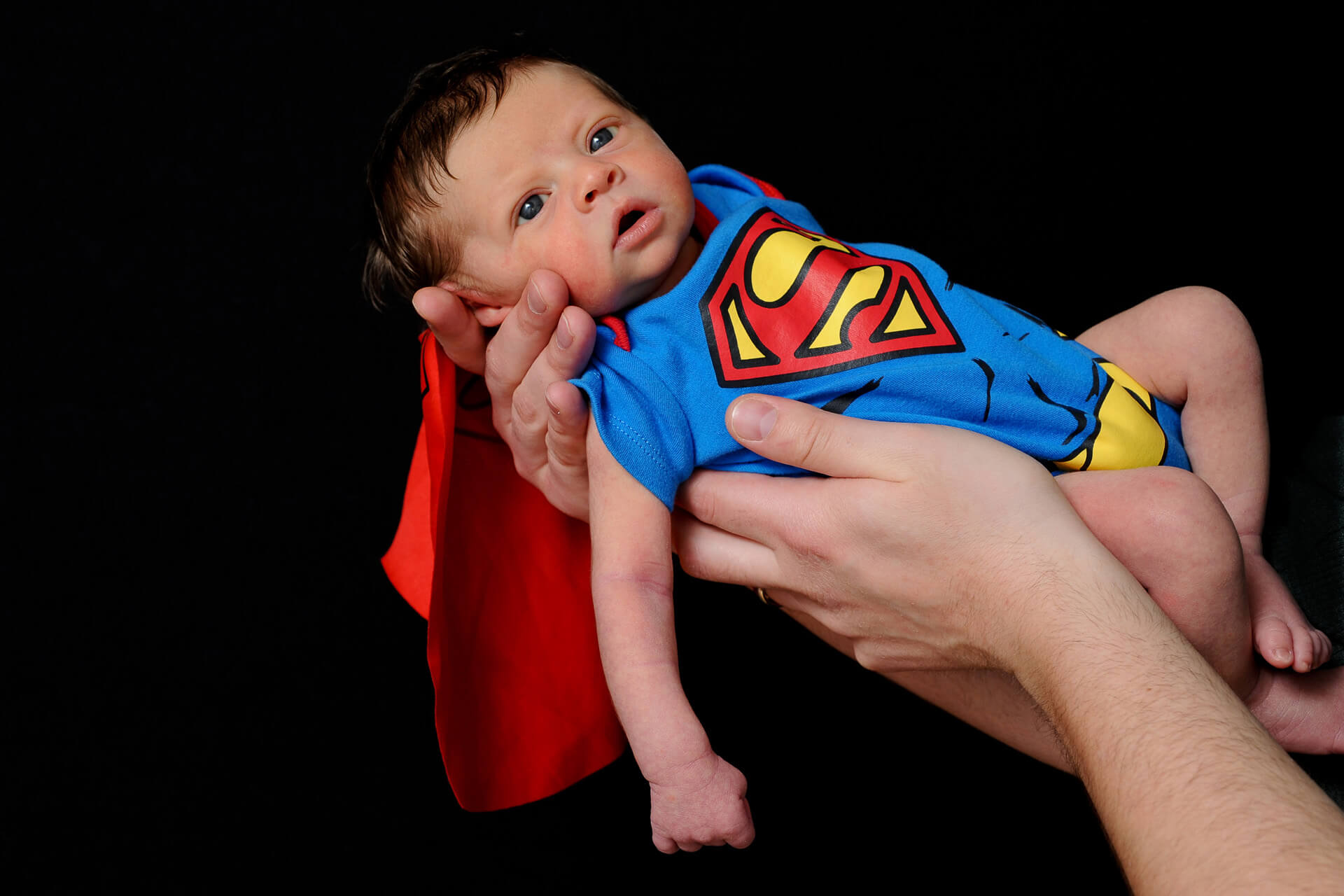 Best Detroit baby photographer's fun and candid infant photos combine fun activities like being a super hero in metro Detroit, Michigan.