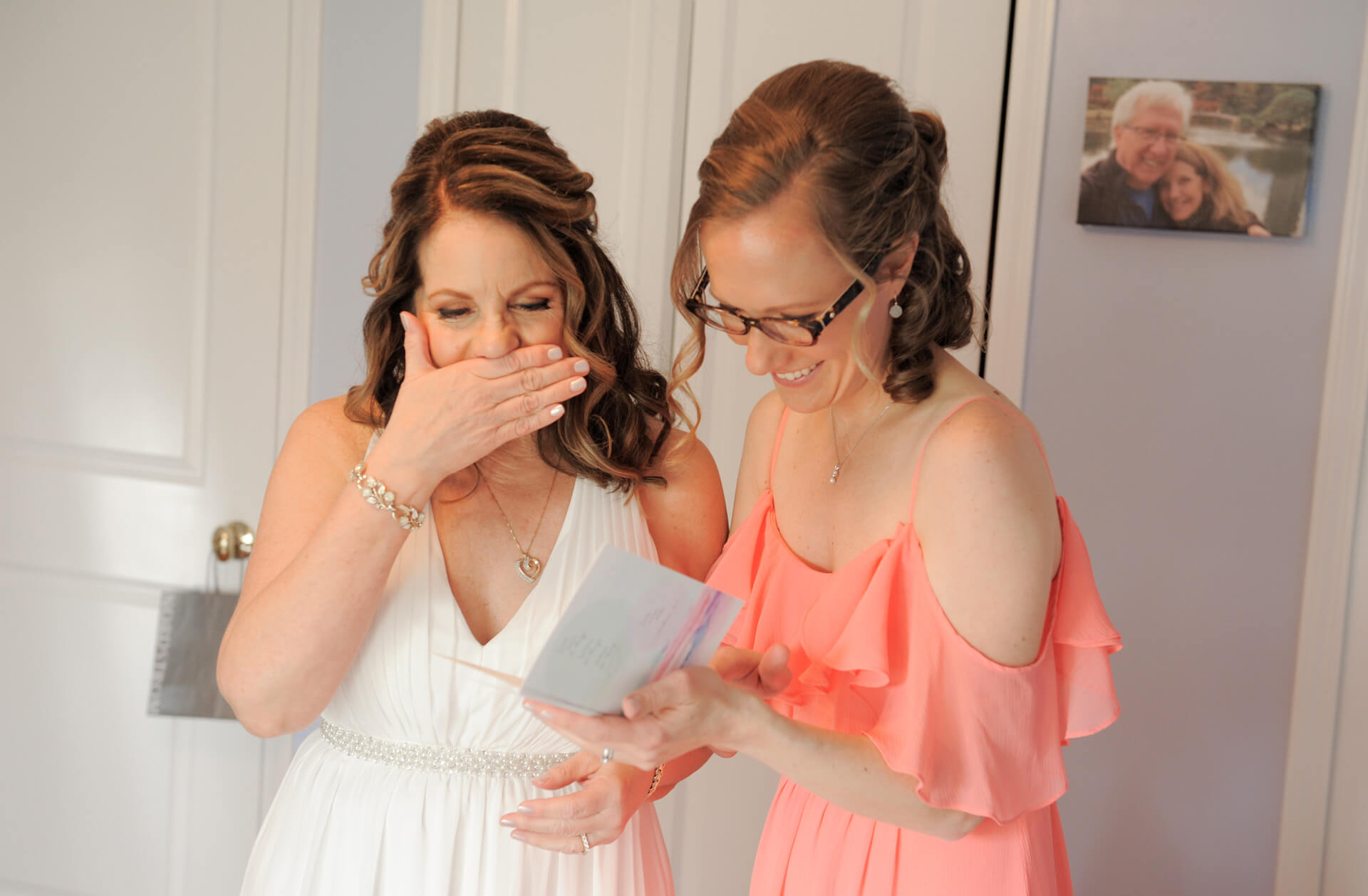 Documentary wedding photo of the bride and her new step daughter reading a note from her groom before heading off to their wedding in Detroit, Michigan.