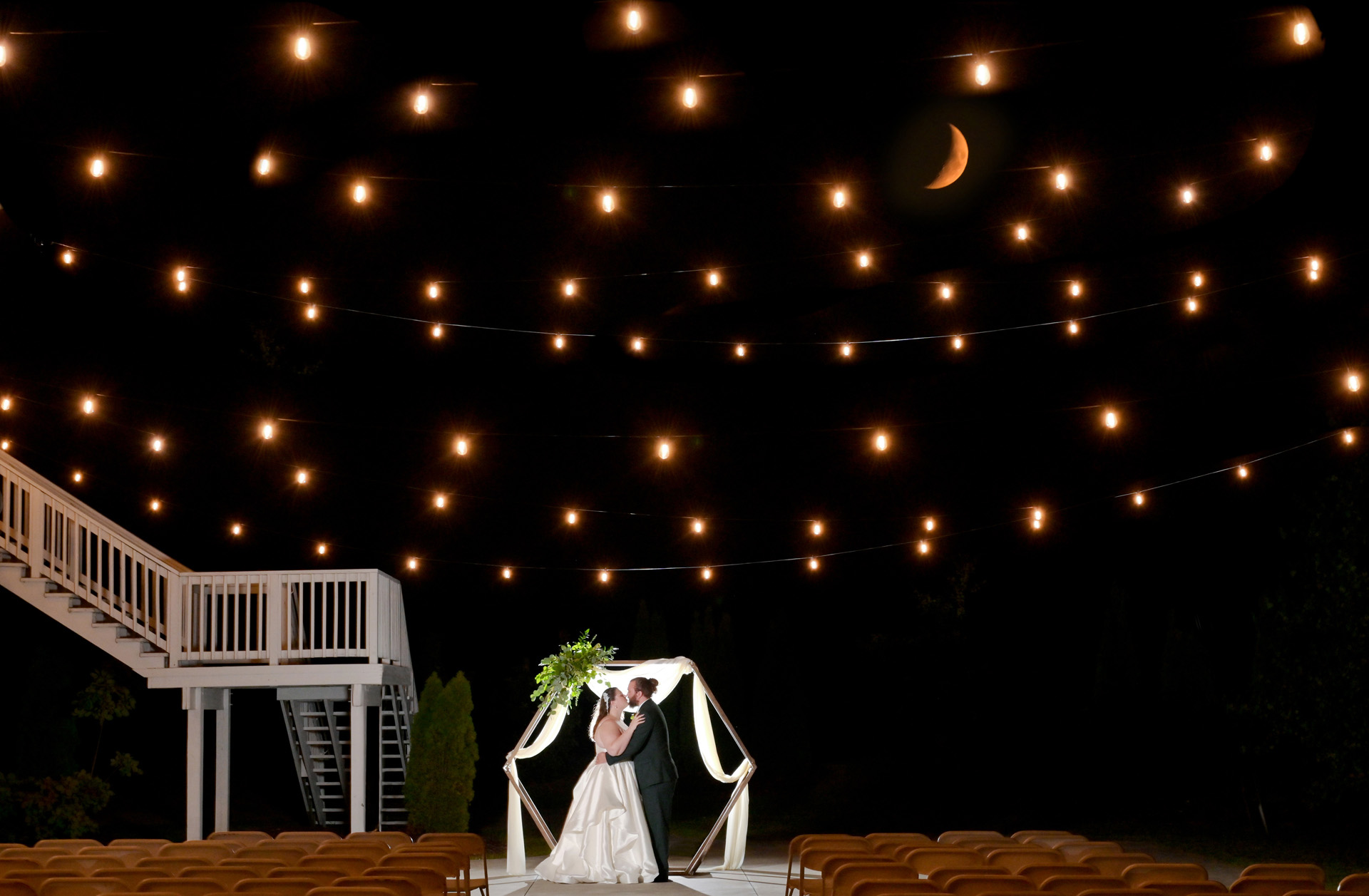 The bride and groom pose for a cool photo with a rising half moon in this fantasy epic wedding portraits at the Captain's Club at Woodfield in Grand Blanc, Michigan.