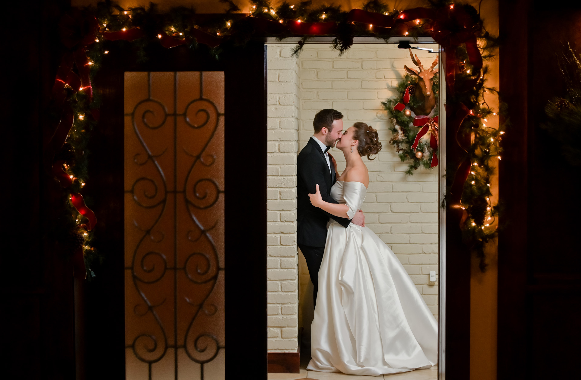 A couple kiss during their wedding reception at the Iroquois Club in Bloomfield Hills, Michigan.