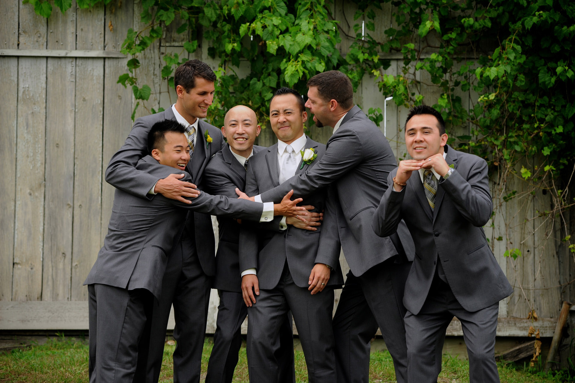 Pine Trace Golf Club wedding photographer's photo of the groom and groomsmen goofing off before their Troy , Michigan wedding.