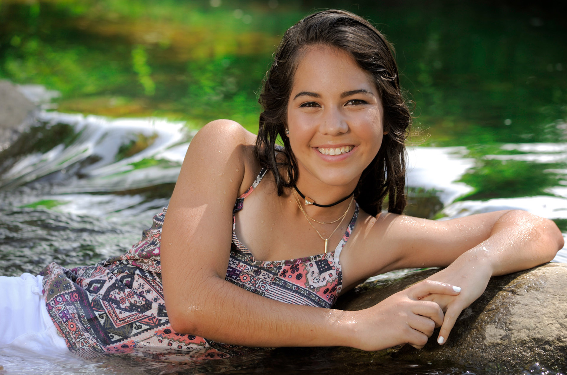 Best Rochester lifestyles photographer covers all the bases of classic children's and kids portraits and lifestyle candid children's and kids photography in Metro Detroit and Rochester, Michigan like this senior laying in the river during the hot summer.